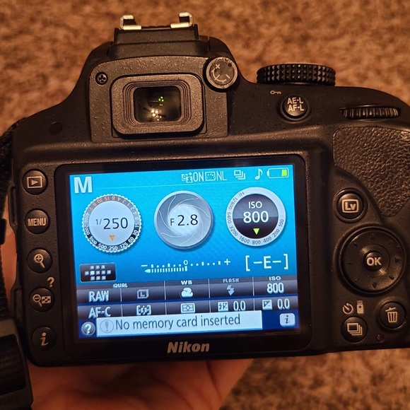 Nikon D3300 Camera with 35mm lens, charger, and carrying bag.